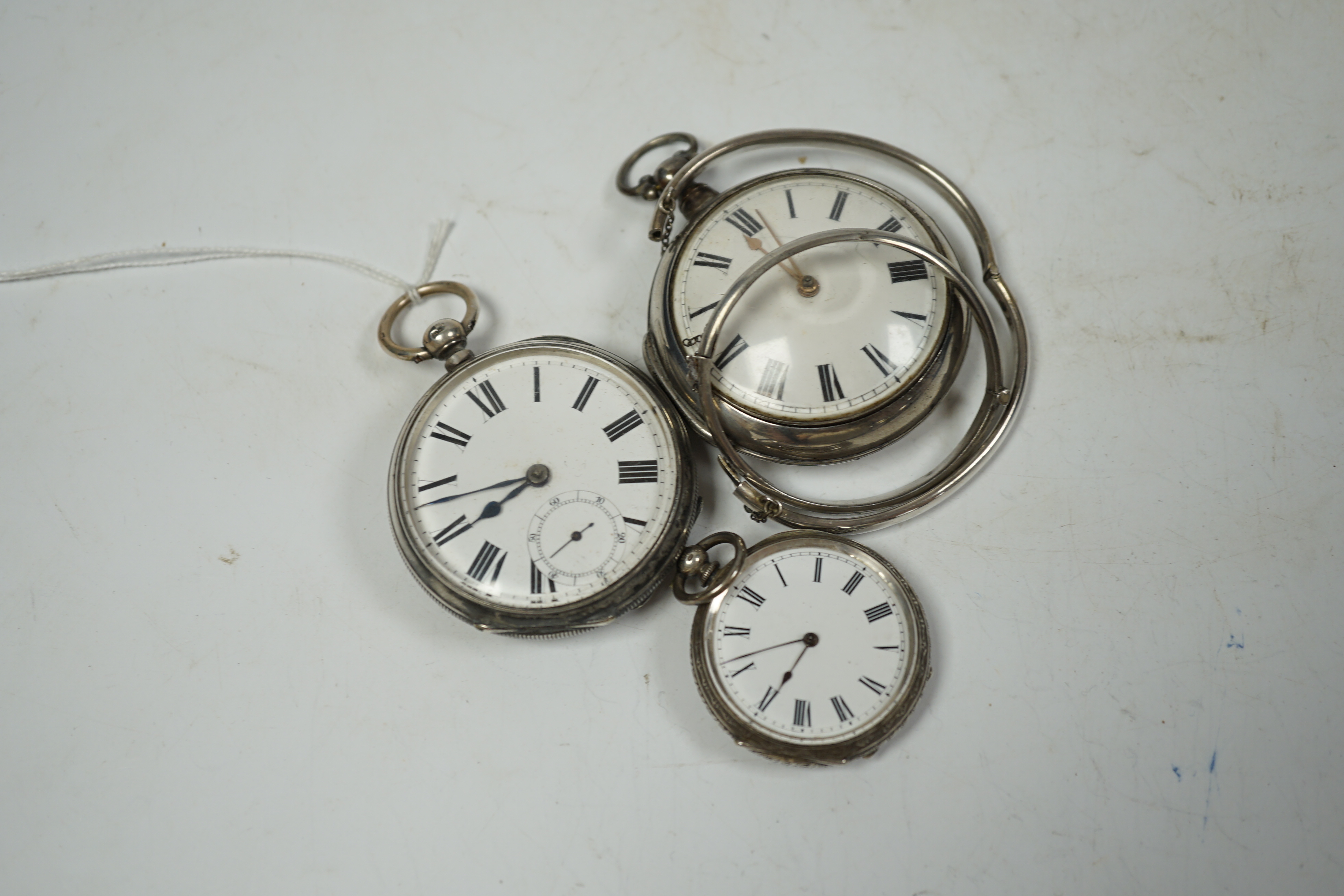 A George III silver pair cased verge key wind pocket watch, by John Thomas, London, one other later silver pocket watch, a white metal fob watch and two silver hinged bangles.